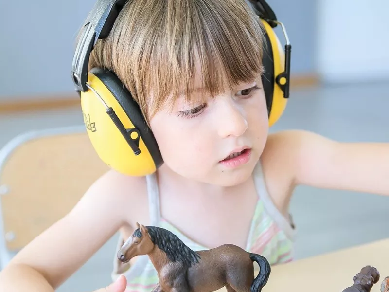 Enfant jouant avec un casque anti-bruit